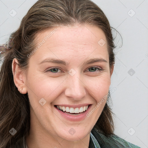 Joyful white young-adult female with long  brown hair and blue eyes