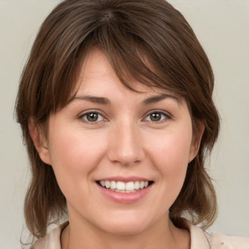 Joyful white young-adult female with medium  brown hair and brown eyes