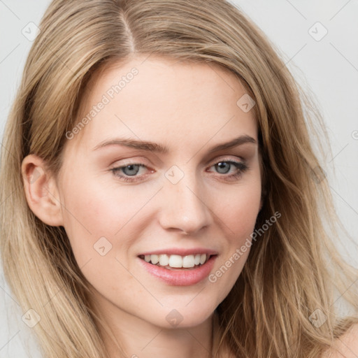 Joyful white young-adult female with long  brown hair and blue eyes