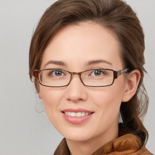 Joyful white young-adult female with medium  brown hair and blue eyes