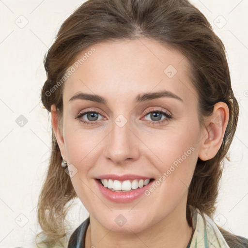 Joyful white young-adult female with medium  brown hair and grey eyes