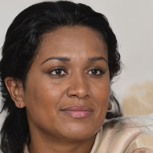 Joyful black adult female with medium  brown hair and brown eyes