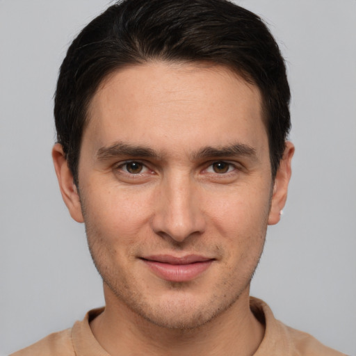 Joyful white young-adult male with short  brown hair and brown eyes