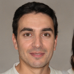 Joyful white adult male with short  brown hair and brown eyes