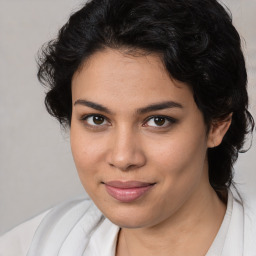 Joyful latino young-adult female with medium  brown hair and brown eyes