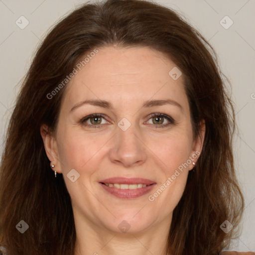 Joyful white adult female with long  brown hair and brown eyes