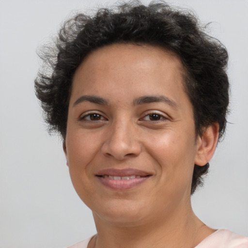 Joyful latino young-adult female with short  brown hair and brown eyes