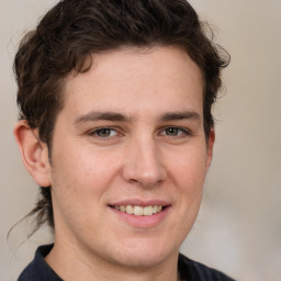 Joyful white young-adult male with medium  brown hair and brown eyes