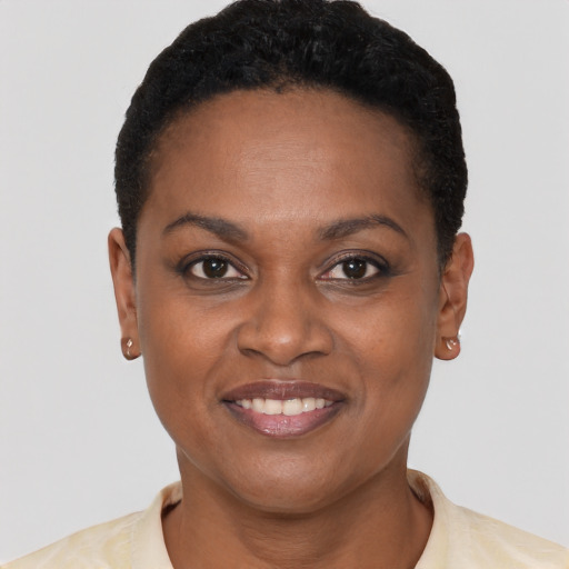 Joyful black young-adult female with short  brown hair and brown eyes