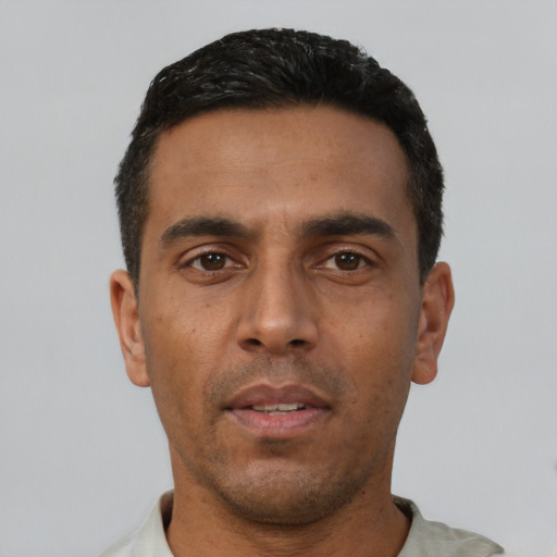 Neutral latino young-adult male with short  black hair and brown eyes