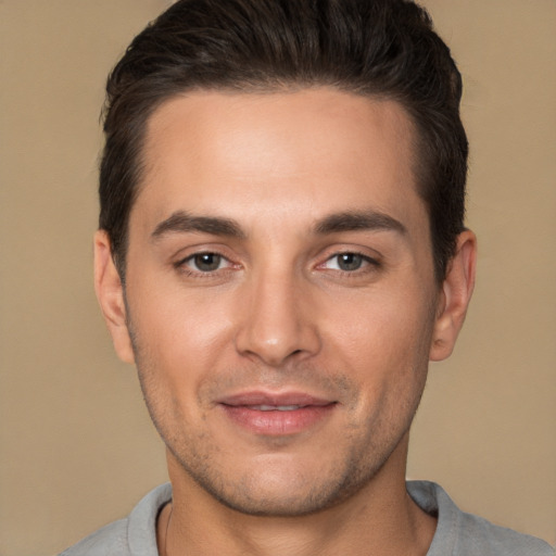 Joyful white young-adult male with short  brown hair and brown eyes