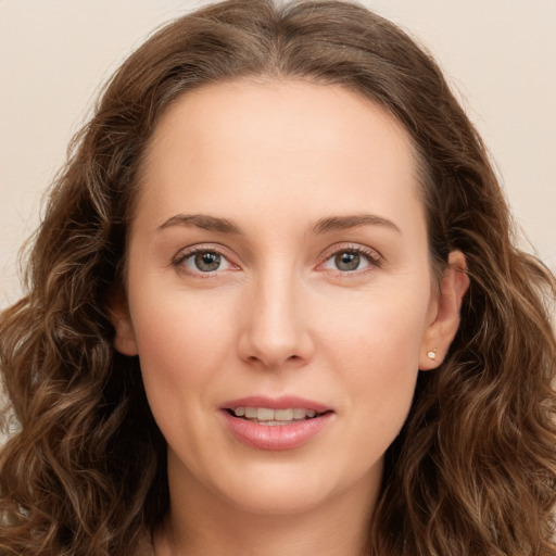 Joyful white young-adult female with long  brown hair and green eyes