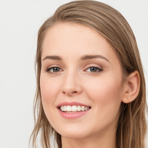 Joyful white young-adult female with long  brown hair and grey eyes