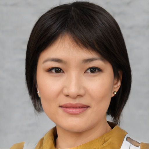 Joyful asian young-adult female with medium  brown hair and brown eyes