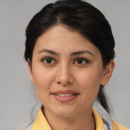 Joyful latino young-adult female with medium  brown hair and brown eyes