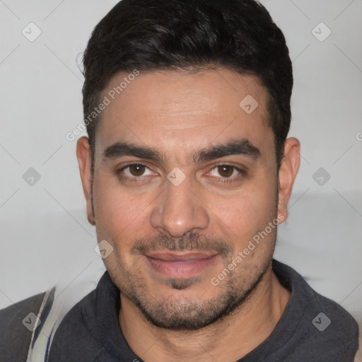 Joyful white young-adult male with short  black hair and brown eyes