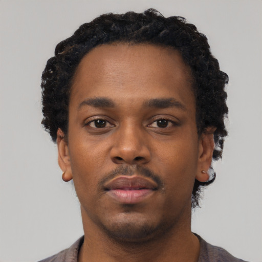 Neutral black young-adult male with short  black hair and brown eyes