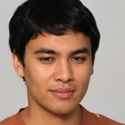 Joyful asian young-adult male with short  brown hair and brown eyes