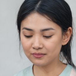 Joyful asian young-adult female with medium  brown hair and brown eyes