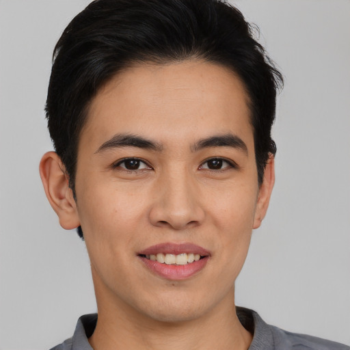 Joyful white young-adult male with short  black hair and brown eyes