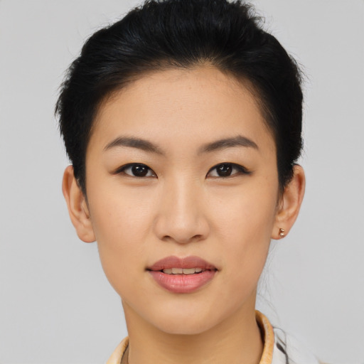 Joyful asian young-adult female with short  brown hair and brown eyes