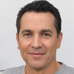 Joyful white adult male with short  black hair and brown eyes