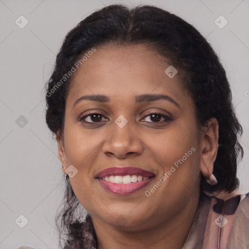 Joyful black adult female with long  brown hair and brown eyes