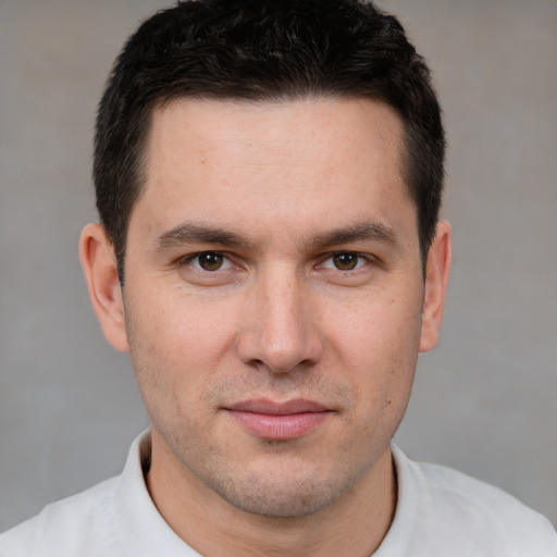 Joyful white young-adult male with short  brown hair and brown eyes