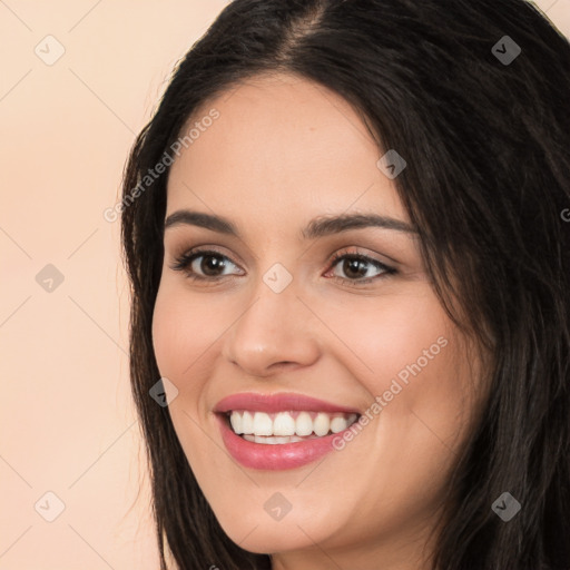 Joyful white young-adult female with long  black hair and brown eyes