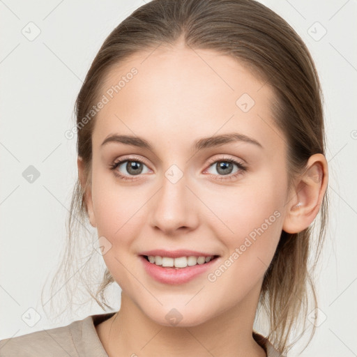 Joyful white young-adult female with medium  brown hair and grey eyes