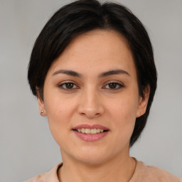 Joyful asian young-adult female with medium  brown hair and brown eyes