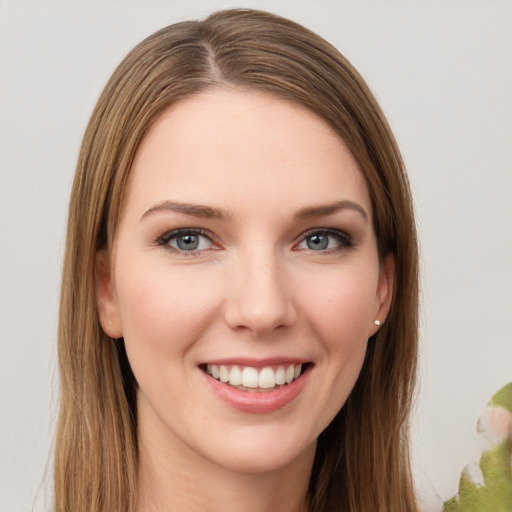 Joyful white young-adult female with long  brown hair and green eyes