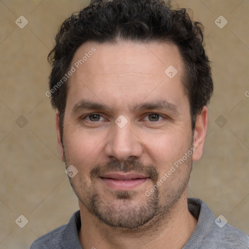 Joyful white adult male with short  black hair and brown eyes