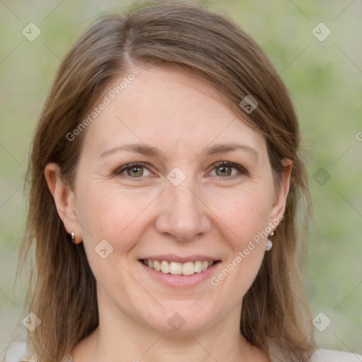 Joyful white adult female with medium  brown hair and grey eyes