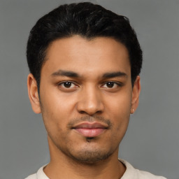 Joyful latino young-adult male with short  black hair and brown eyes