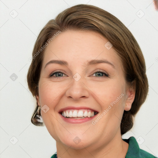 Joyful white adult female with medium  brown hair and green eyes