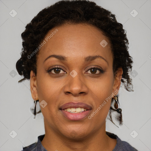 Joyful black adult female with short  brown hair and brown eyes