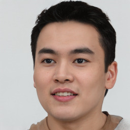 Joyful asian young-adult male with short  black hair and brown eyes