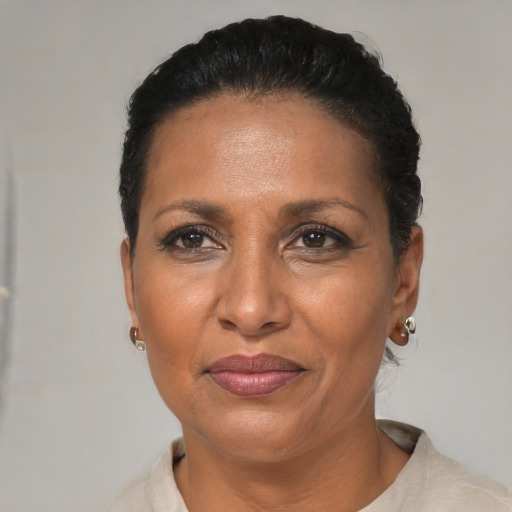 Joyful black adult female with short  black hair and brown eyes