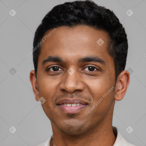 Joyful black young-adult male with short  black hair and brown eyes