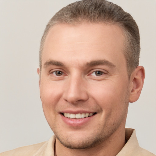 Joyful white adult male with short  brown hair and brown eyes