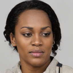 Joyful black young-adult female with medium  brown hair and brown eyes