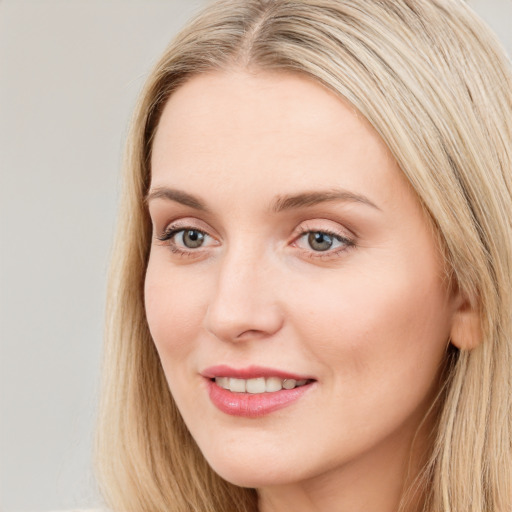 Joyful white young-adult female with long  brown hair and blue eyes