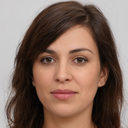 Joyful white young-adult female with long  brown hair and brown eyes