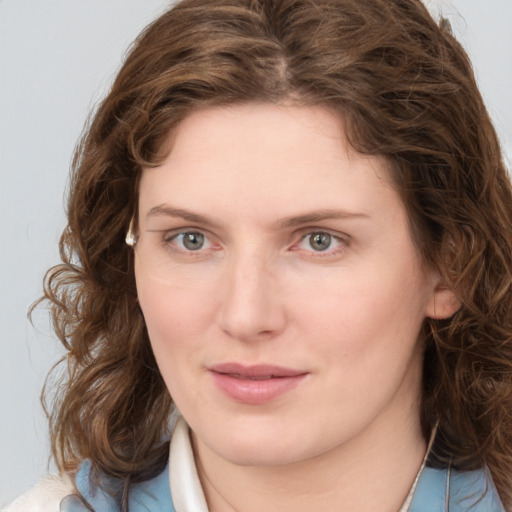 Joyful white young-adult female with medium  brown hair and blue eyes