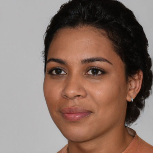 Joyful latino young-adult female with short  black hair and brown eyes