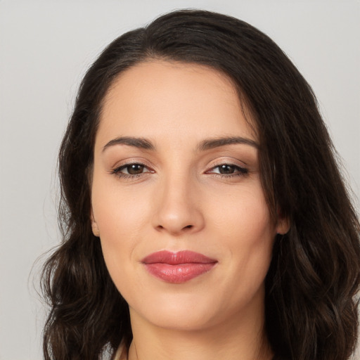 Joyful white young-adult female with long  brown hair and brown eyes