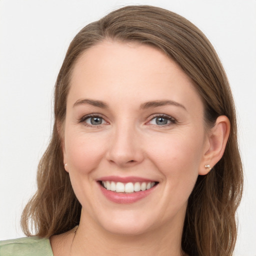 Joyful white young-adult female with long  brown hair and grey eyes