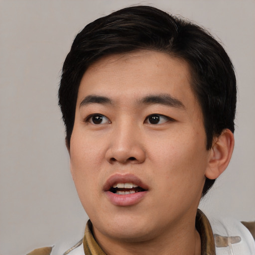 Joyful white young-adult male with short  black hair and brown eyes