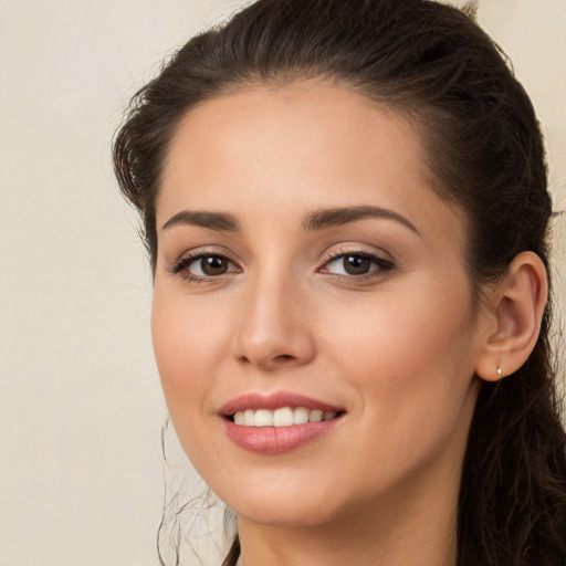 Joyful white young-adult female with long  brown hair and brown eyes